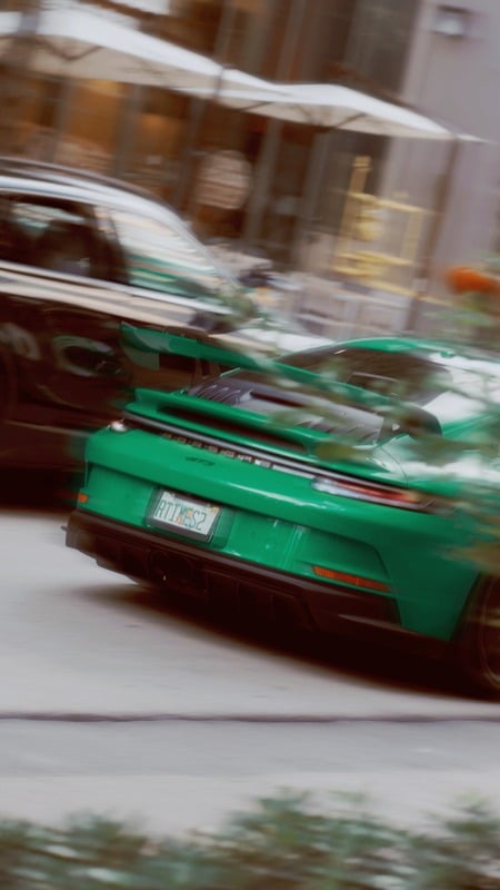 Green Porsche in motion