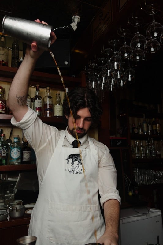 Bartender at work in a dark bar